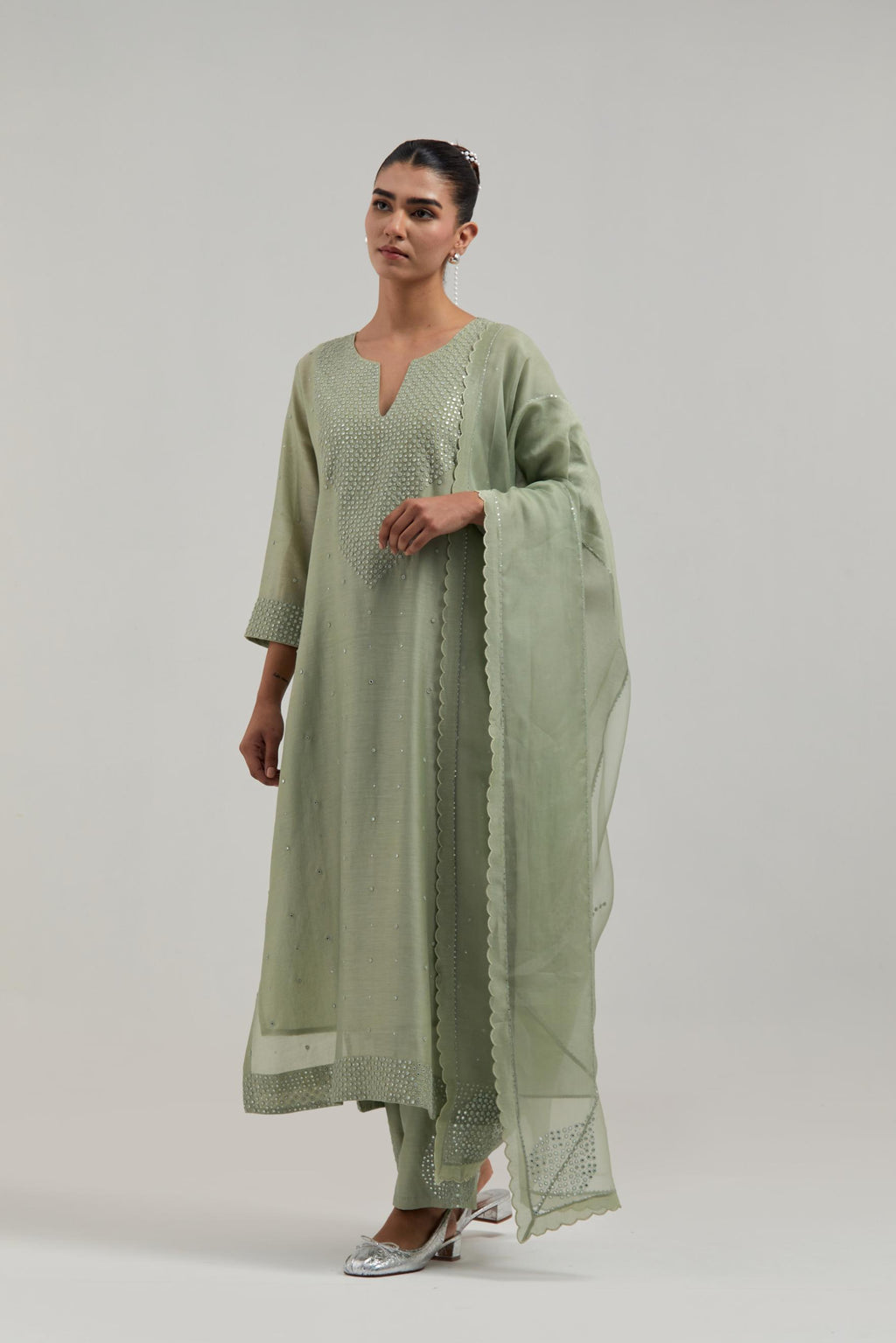 Green silk Chanderi dupatta with silk organza at the sides, finished with delicate scalloped edges, highlighted by hand-embroidered mirror & sequins work.