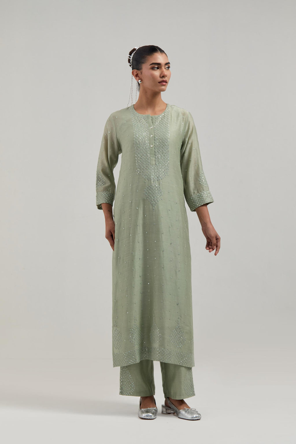 Green silk Chanderi straight kurta set with hand-embroidered mirror at the neck, borders running along the hem and sleeve edges, and scattered silver sequin and mirror embellishments all-over.