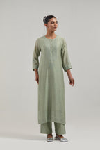 Green silk Chanderi straight kurta set with hand-embroidered mirror at the neck, borders running along the hem and sleeve edges, and scattered silver sequin and mirror embellishments all-over.