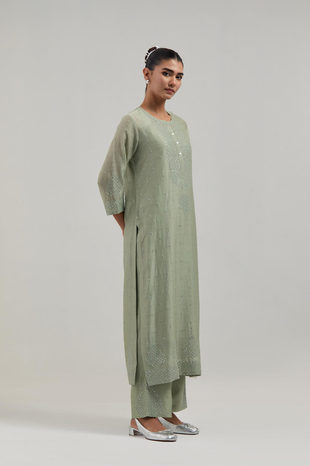 Green silk Chanderi straight kurta set with hand-embroidered mirror at the neck, borders running along the hem and sleeve edges, and scattered silver sequin and mirror embellishments all-over.