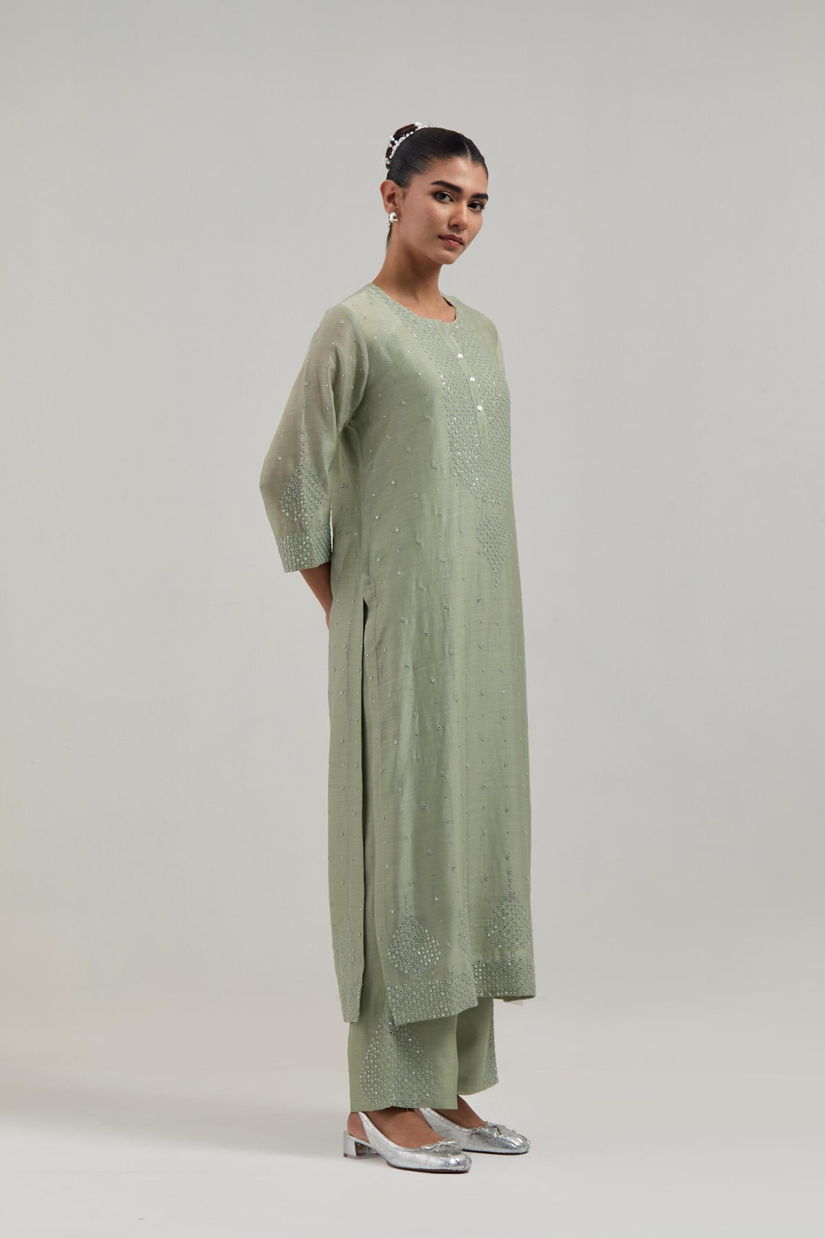 Green silk Chanderi straight kurta set with hand-embroidered mirror at the neck, borders running along the hem and sleeve edges, and scattered silver sequin and mirror embellishments all-over.