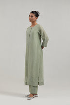 Green silk Chanderi straight kurta set with hand-embroidered mirror at the neck, borders running along the hem and sleeve edges, and scattered silver sequin and mirror embellishments all-over.