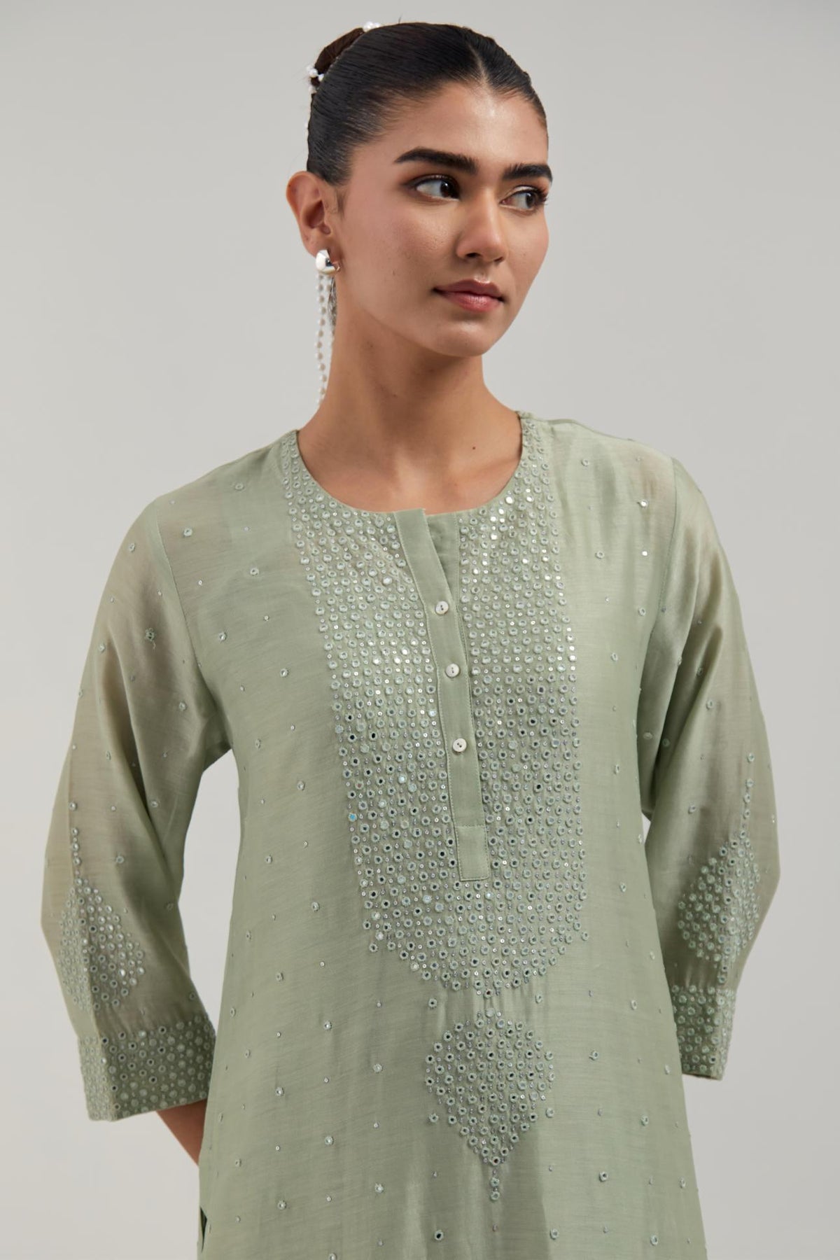 Green silk Chanderi straight kurta set with hand-embroidered mirror at the neck, borders running along the hem and sleeve edges, and scattered silver sequin and mirror embellishments all-over.