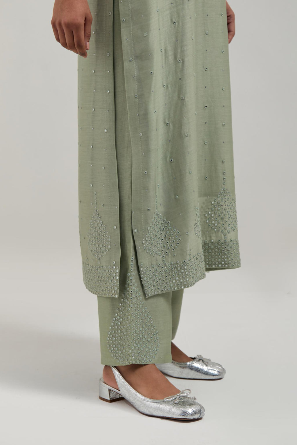 Green silk Chanderi straight kurta set with hand-embroidered mirror at the neck, borders running along the hem and sleeve edges, and scattered silver sequin and mirror embellishments all-over.