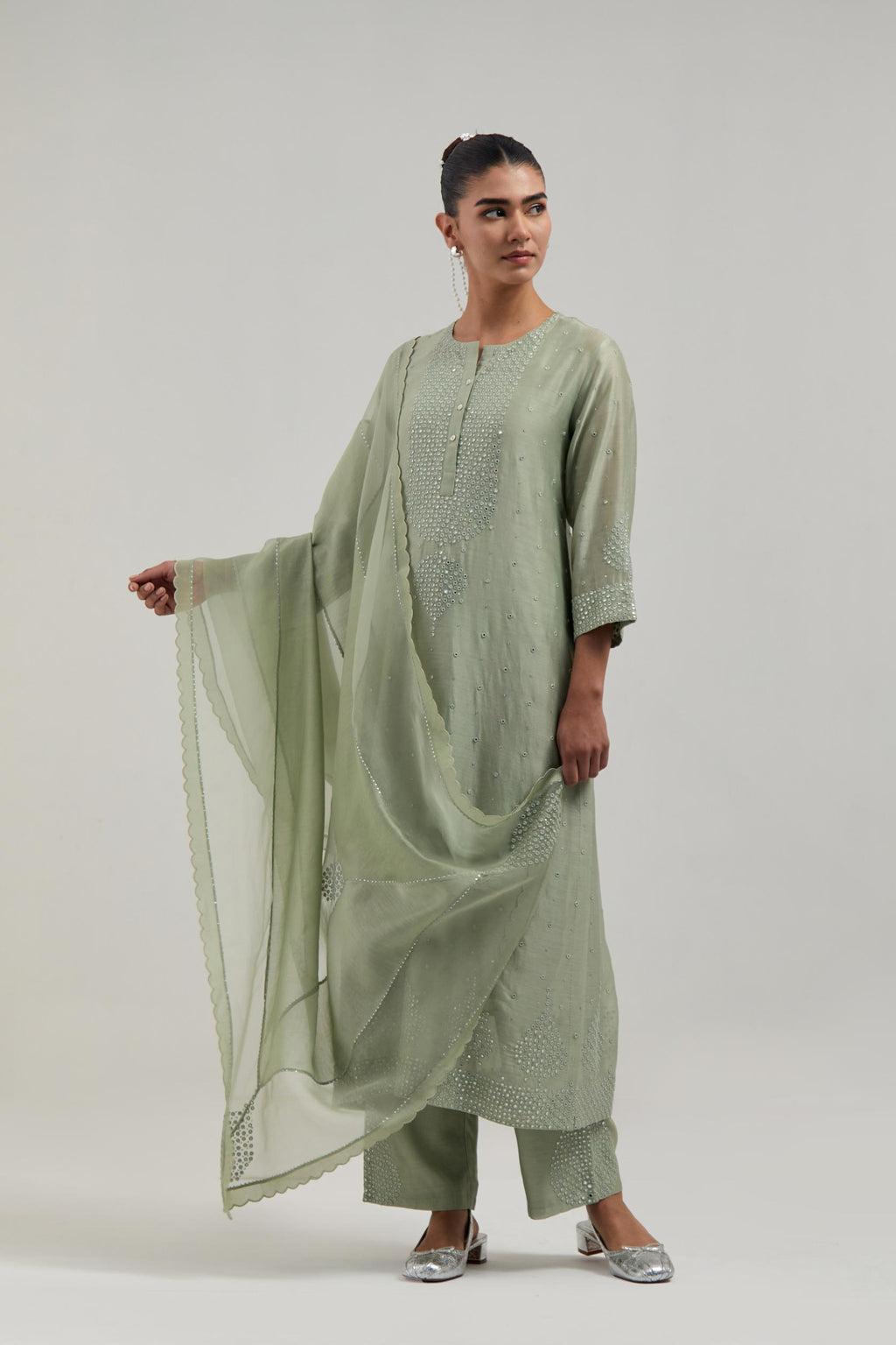 Green silk Chanderi straight kurta set with hand-embroidered mirror at the neck, borders running along the hem and sleeve edges, and scattered silver sequin and mirror embellishments all-over.