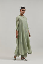Green silk Chanderi long kaftan with hand-embroidered mirror and sequins at the neck and diamond motifs along the sides, paired with Green silk Chanderi straight pants with narrow organza scalloped hem and hand-embroidered diamond motifs with delicate.