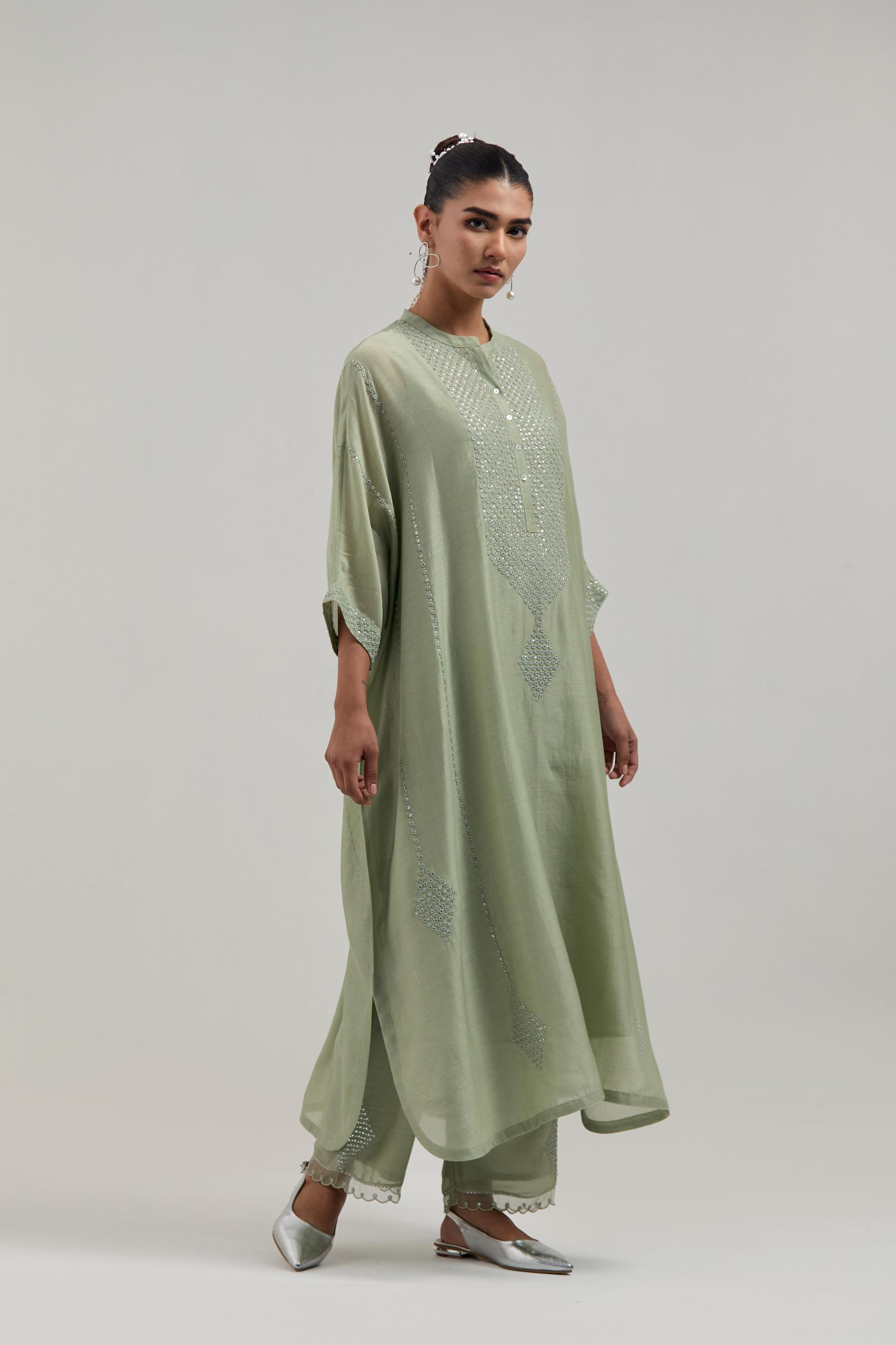 Green silk Chanderi long kaftan with hand-embroidered mirror and sequins at the neck and diamond motifs along the sides, paired with Green silk Chanderi straight pants with narrow organza scalloped hem and hand-embroidered diamond motifs with delicate.