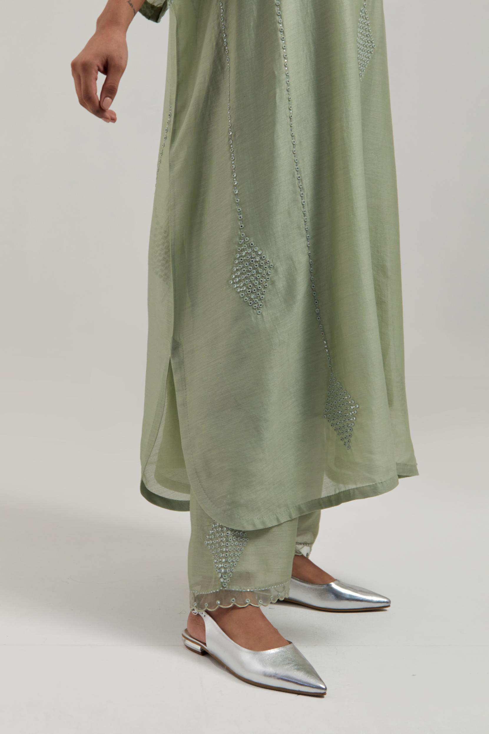 Green silk Chanderi long kaftan with hand-embroidered mirror and sequins at the neck and diamond motifs along the sides, paired with Green silk Chanderi straight pants with narrow organza scalloped hem and hand-embroidered diamond motifs with delicate.