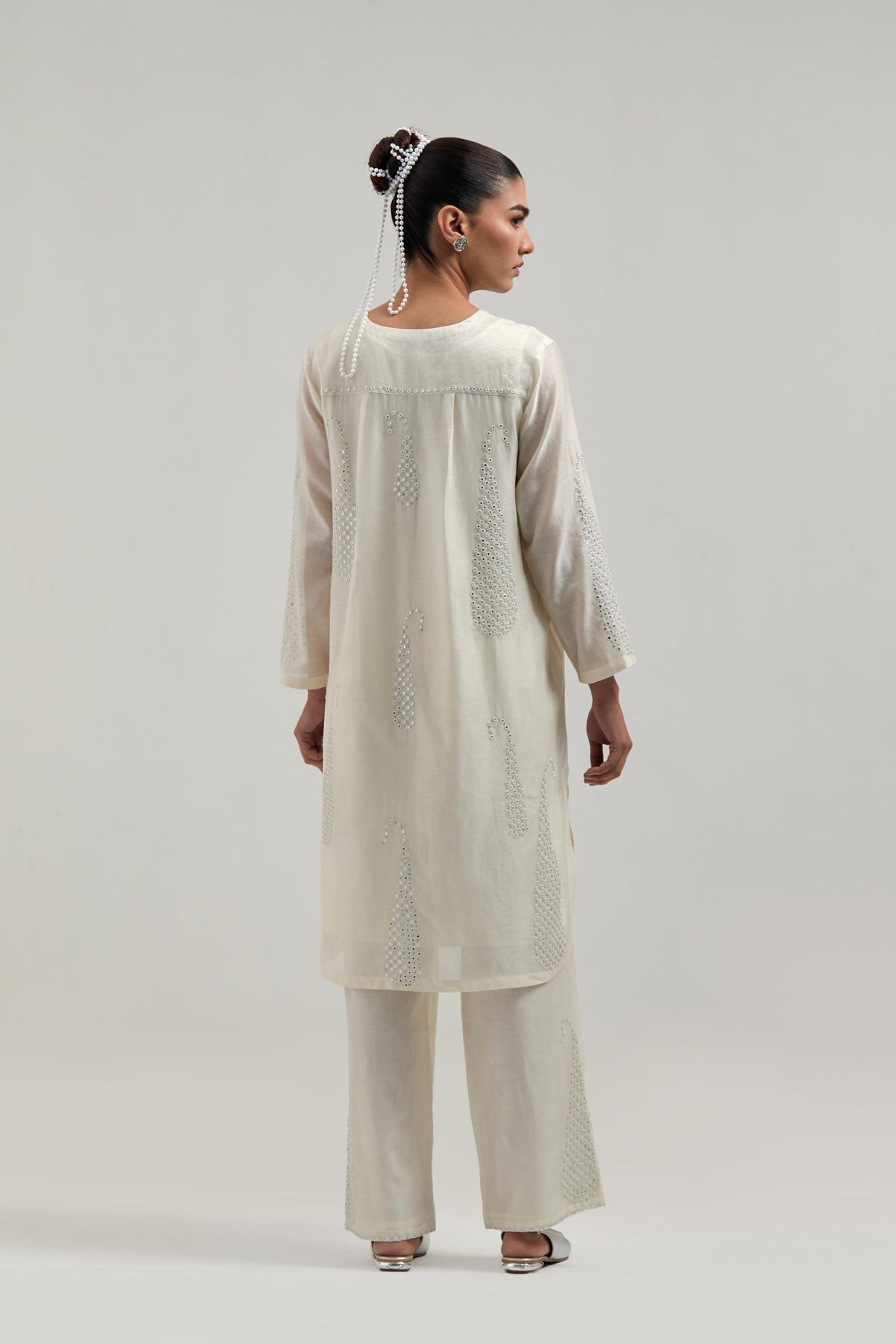 Off white Silk Chanderi short kurta set with hand-embroidered paisley motifs with delicate mirror and sequins work all-over the kurta.