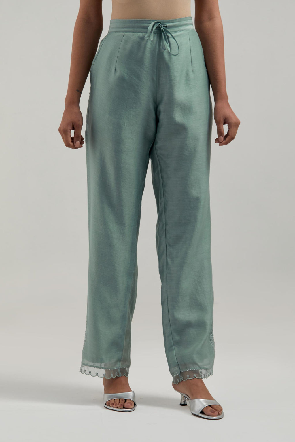 Blue silk Chanderi straight pants with narrow organza scalloped hem and hand-embroidered diamond motifs with delicate mirror & sequins work at the sides.