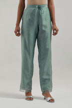 Blue silk Chanderi straight pants with narrow organza scalloped hem and hand-embroidered diamond motifs with delicate mirror & sequins work at the sides.