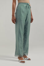Blue silk Chanderi straight pants with narrow organza scalloped hem and hand-embroidered diamond motifs with delicate mirror & sequins work at the sides.