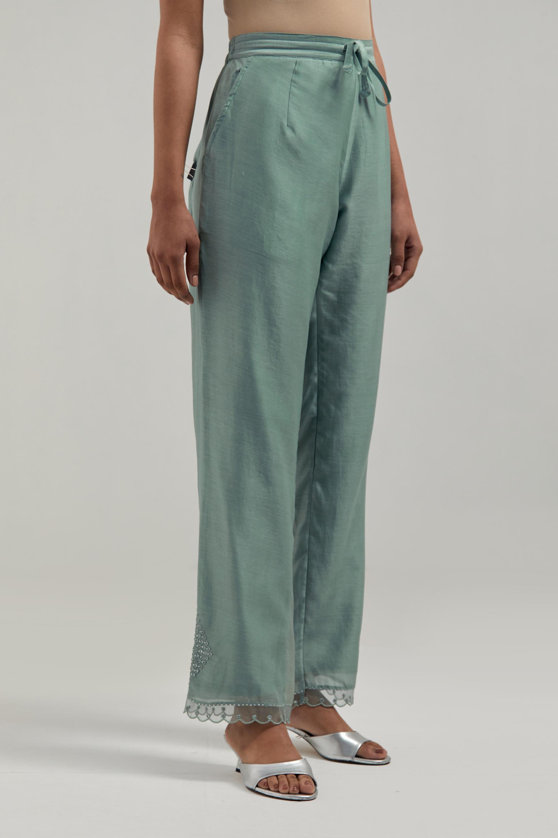 Blue silk Chanderi straight pants with narrow organza scalloped hem and hand-embroidered diamond motifs with delicate mirror & sequins work at the sides.