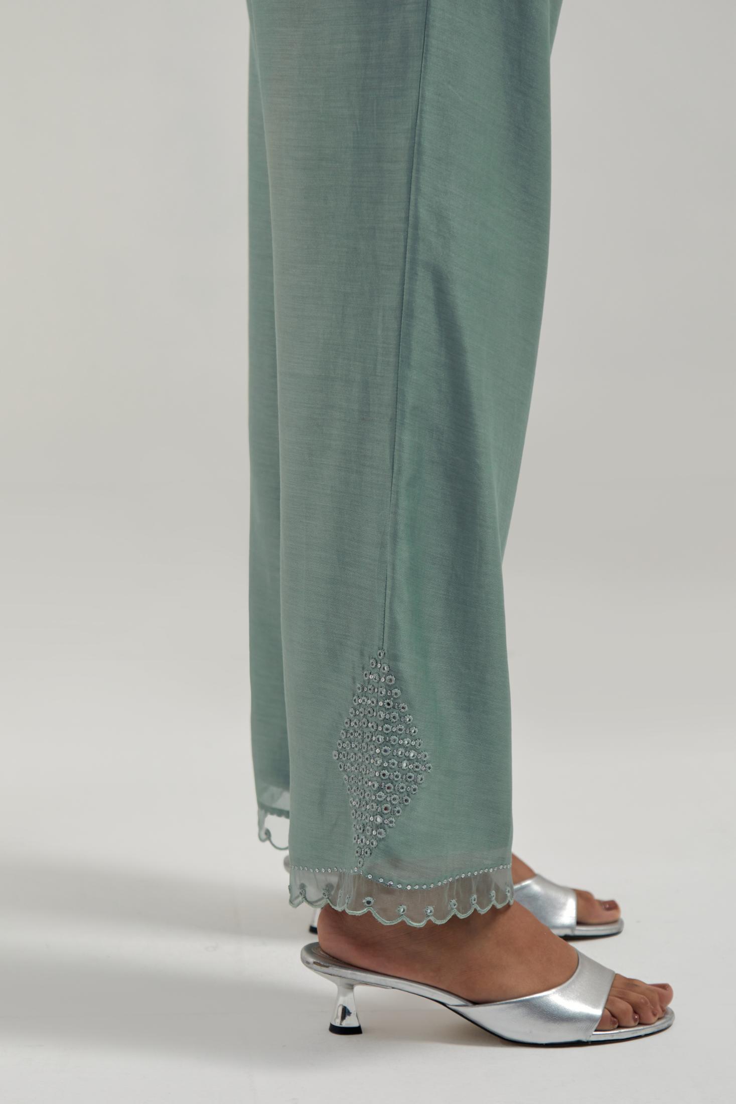 Blue silk Chanderi straight pants with narrow organza scalloped hem and hand-embroidered diamond motifs with delicate mirror & sequins work at the sides.