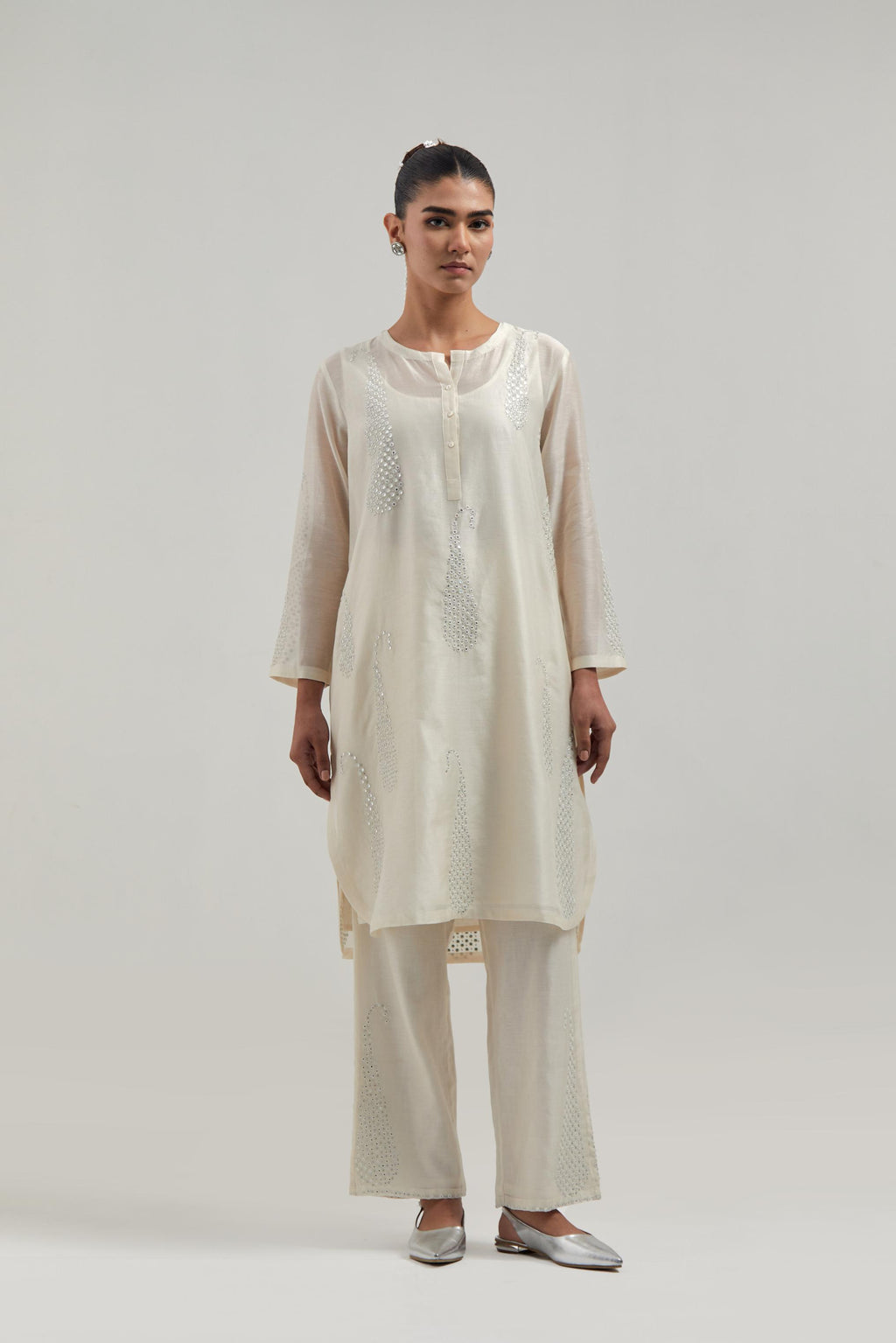 Off white Silk Chanderi short kurta set with hand-embroidered paisley motifs with delicate mirror and sequins work all-over the kurta.