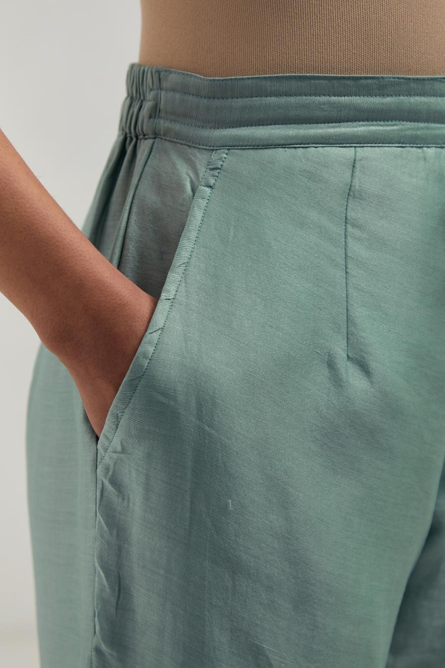 Blue silk Chanderi straight pants with narrow organza scalloped hem and hand-embroidered diamond motifs with delicate mirror & sequins work at the sides.