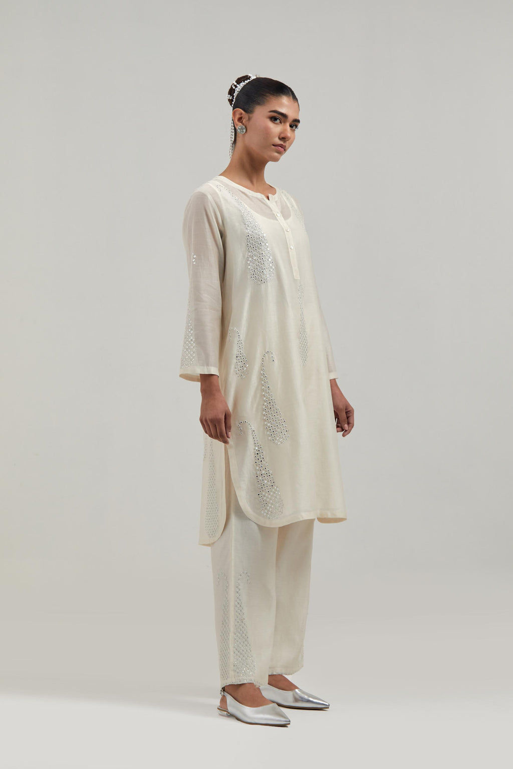 Off white Silk Chanderi short kurta set with hand-embroidered paisley motifs with delicate mirror and sequins work all-over the kurta.