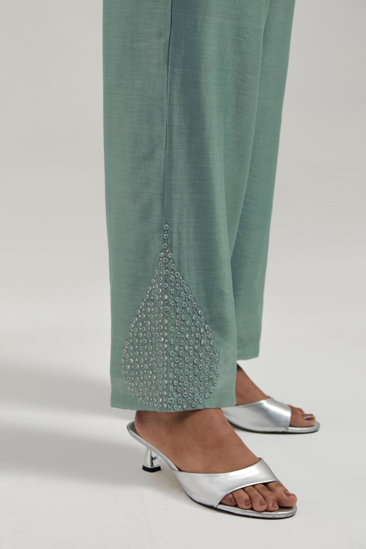 Blue Silk Chanderi pants with hand embroidered leaf motifs with delicate mirror & sequins work at hem.