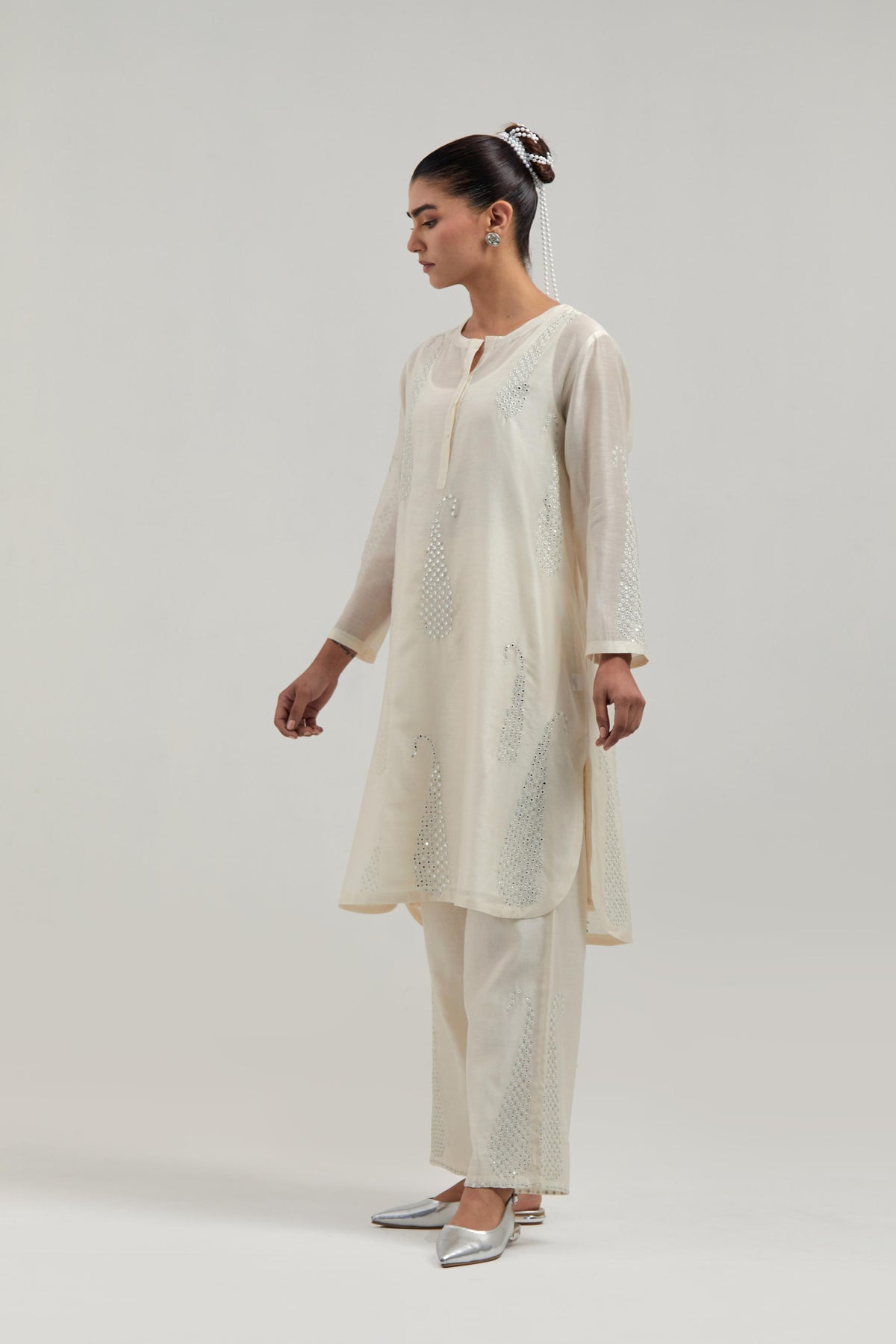 Off white Silk Chanderi short kurta set with hand-embroidered paisley motifs with delicate mirror and sequins work all-over the kurta.