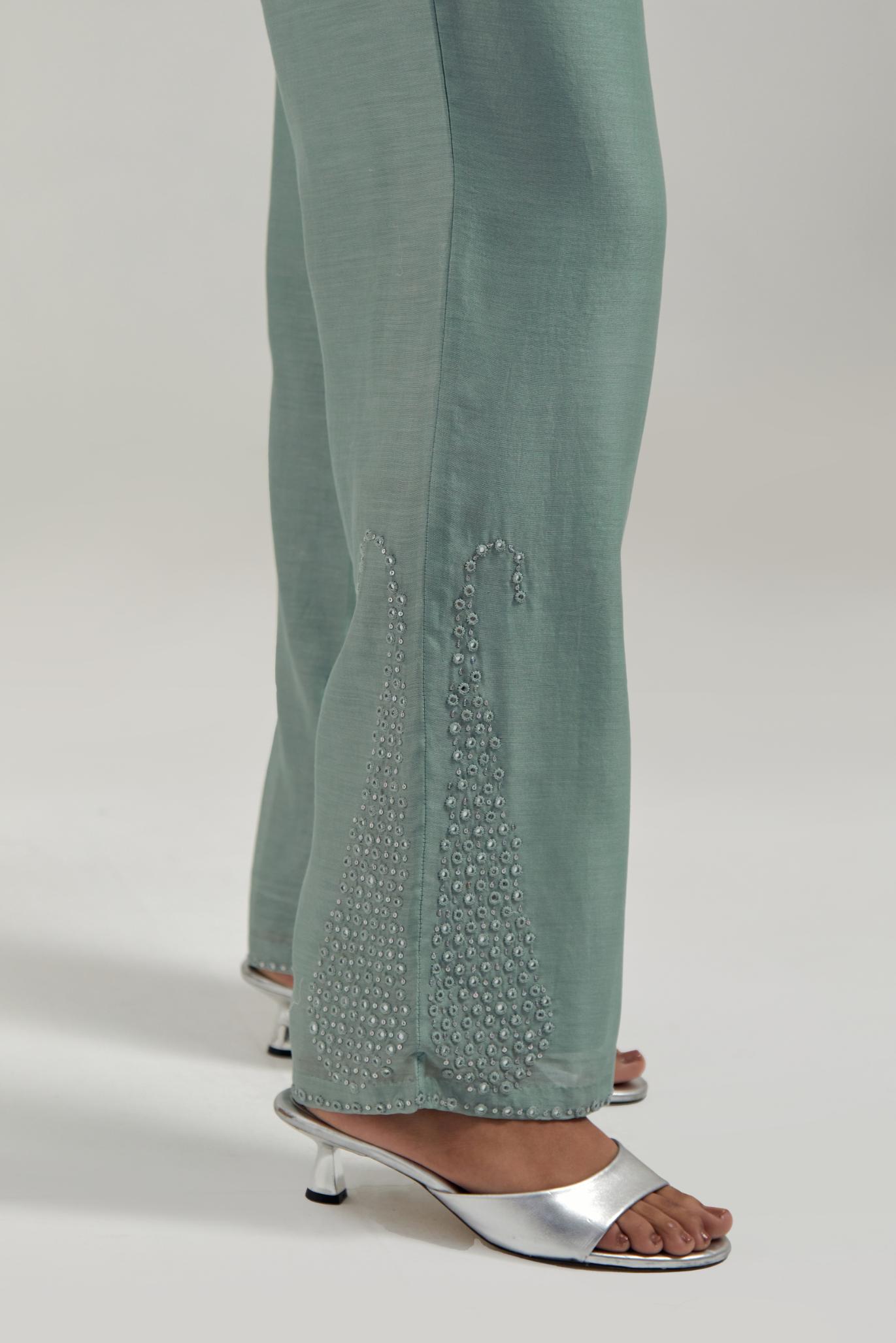 Blue silk Chanderi pants with hand-embroidered paisley motifs with delicate mirror and sequins work at the hem.