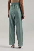 Blue silk Chanderi pants with hand-embroidered paisley motifs with delicate mirror and sequins work at the hem.