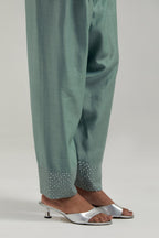 Blue silk Chanderi salwar with hand-embroidered mirror & sequins work in a broad border at the hem.