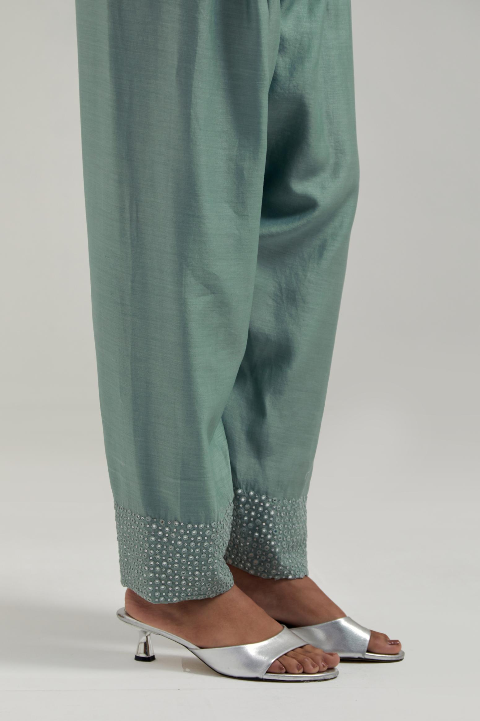 Blue silk Chanderi salwar with hand-embroidered mirror & sequins work in a broad border at the hem.