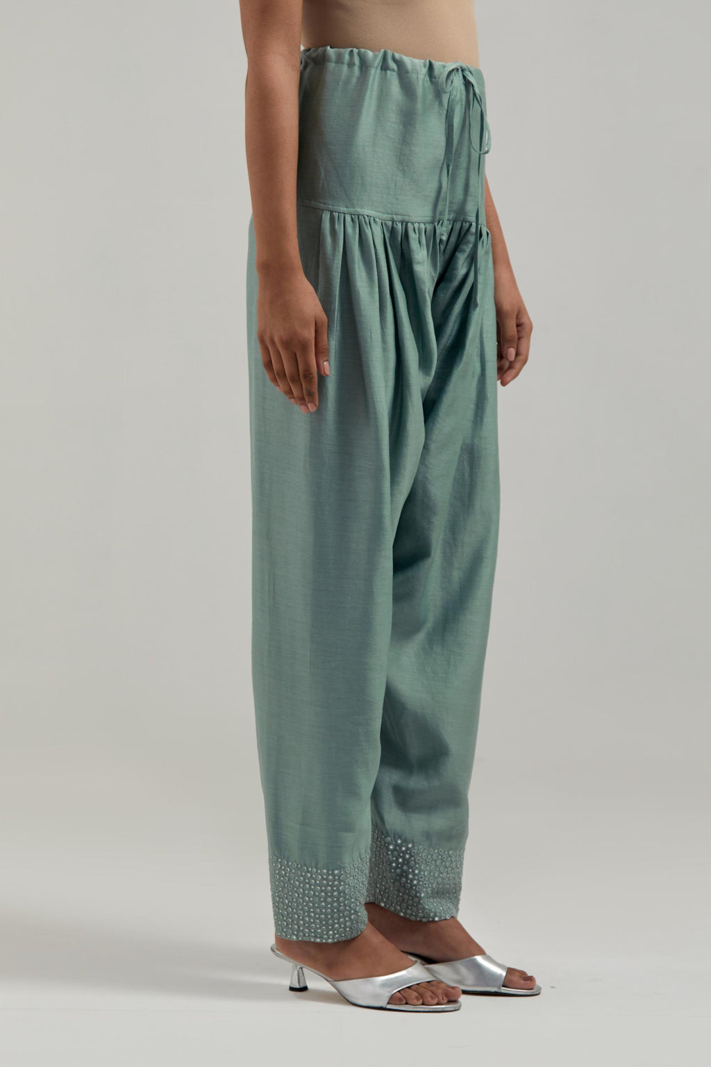 Blue silk Chanderi salwar with hand-embroidered mirror & sequins work in a broad border at the hem.