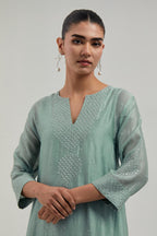 Blue silk Chanderi short kalidar kurta set, with hand embroidered mirror at neck, hem and sleeve edges, highlighted with scattered silver sequins and mirror embellishments all-over.