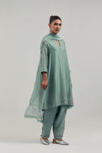 Blue silk Chanderi short kalidar kurta set, with hand embroidered mirror at neck, hem and sleeve edges, highlighted with scattered silver sequins and mirror embellishments all-over.