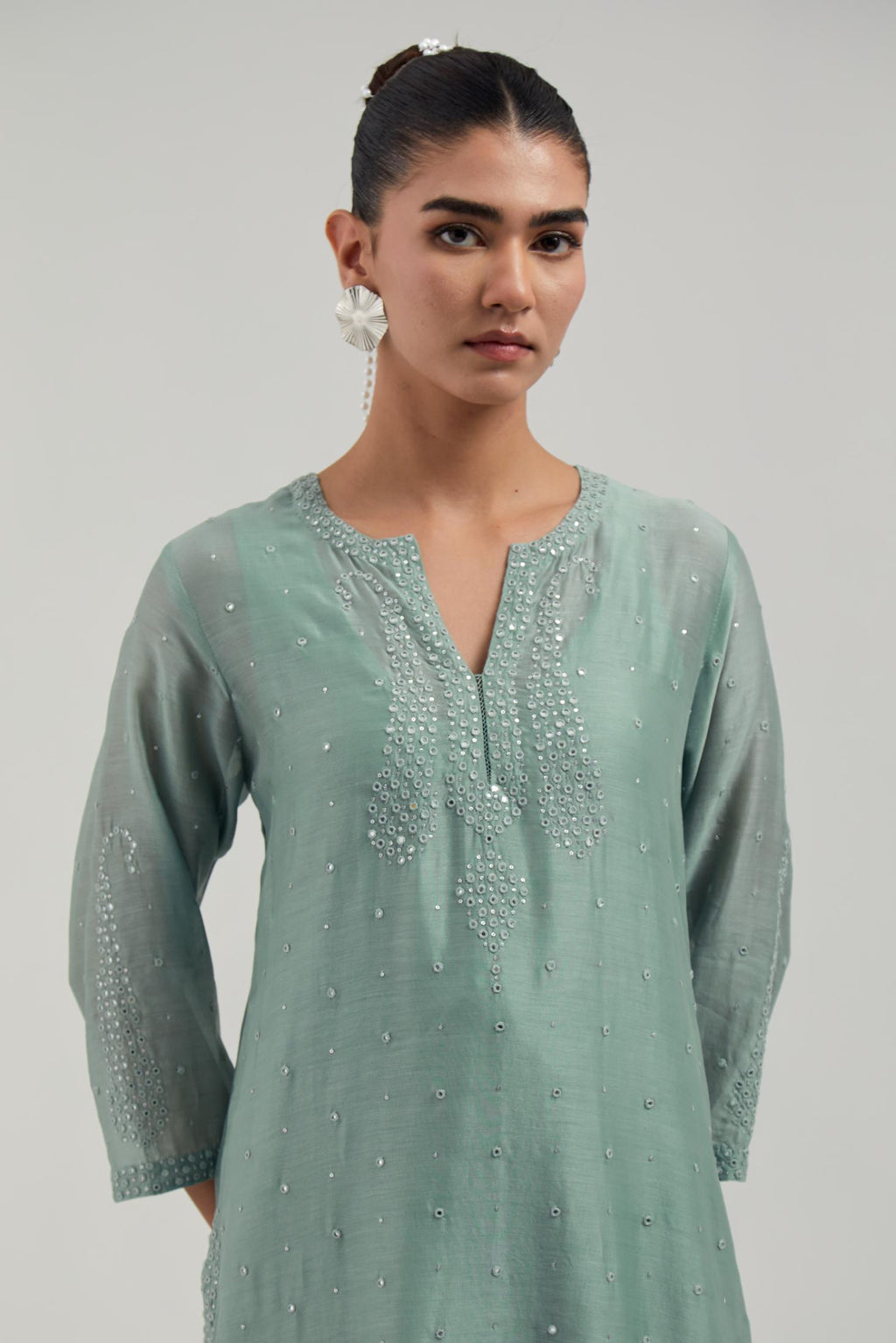 Blue silk Chanderi straight kurta set with hand-embroidered paisley motifs with delicate mirror and sequins work at neck, hem, and sleeves, with narrow borders along the edges.