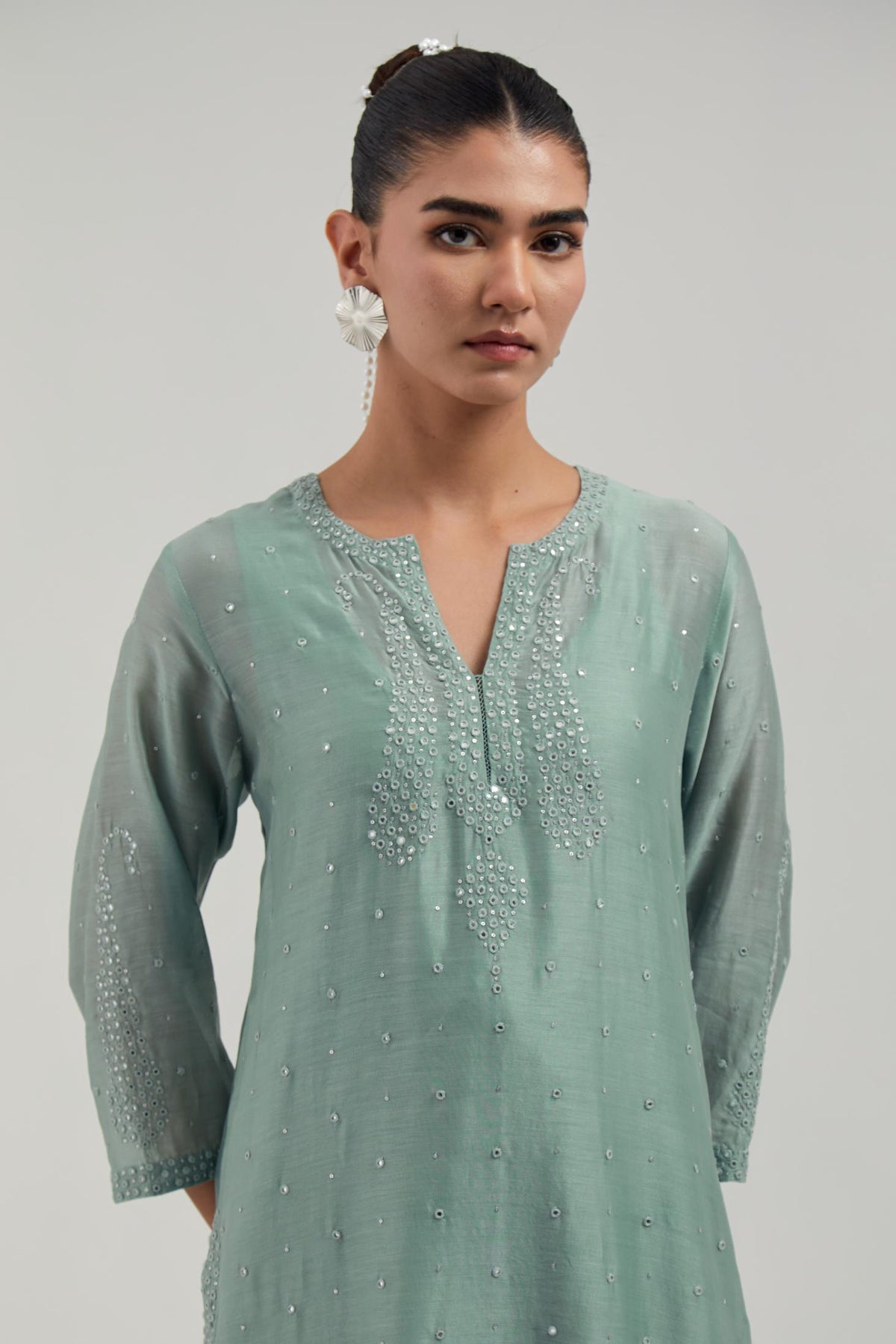 Blue silk Chanderi straight kurta set with hand-embroidered paisley motifs with delicate mirror and sequins work at neck, hem, and sleeves, with narrow borders along the edges.