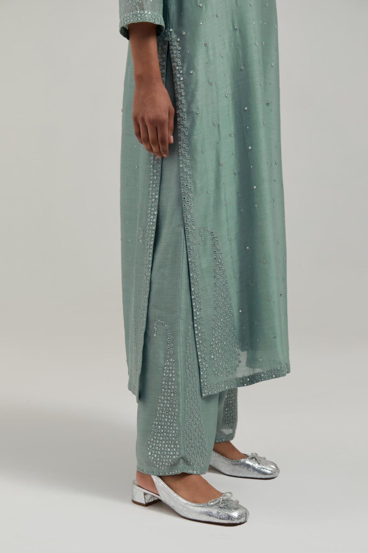 Blue silk Chanderi straight kurta set with hand-embroidered paisley motifs with delicate mirror and sequins work at neck, hem, and sleeves, with narrow borders along the edges.
