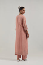 Peach silk Chanderi straight kurta set with all-over hand embroidered mirror and silver sequins.