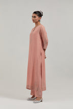 Peach silk Chanderi straight kurta set with all-over hand embroidered mirror and silver sequins.