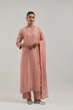 Peach silk Chanderi straight kurta set with all-over hand embroidered mirror and silver sequins.