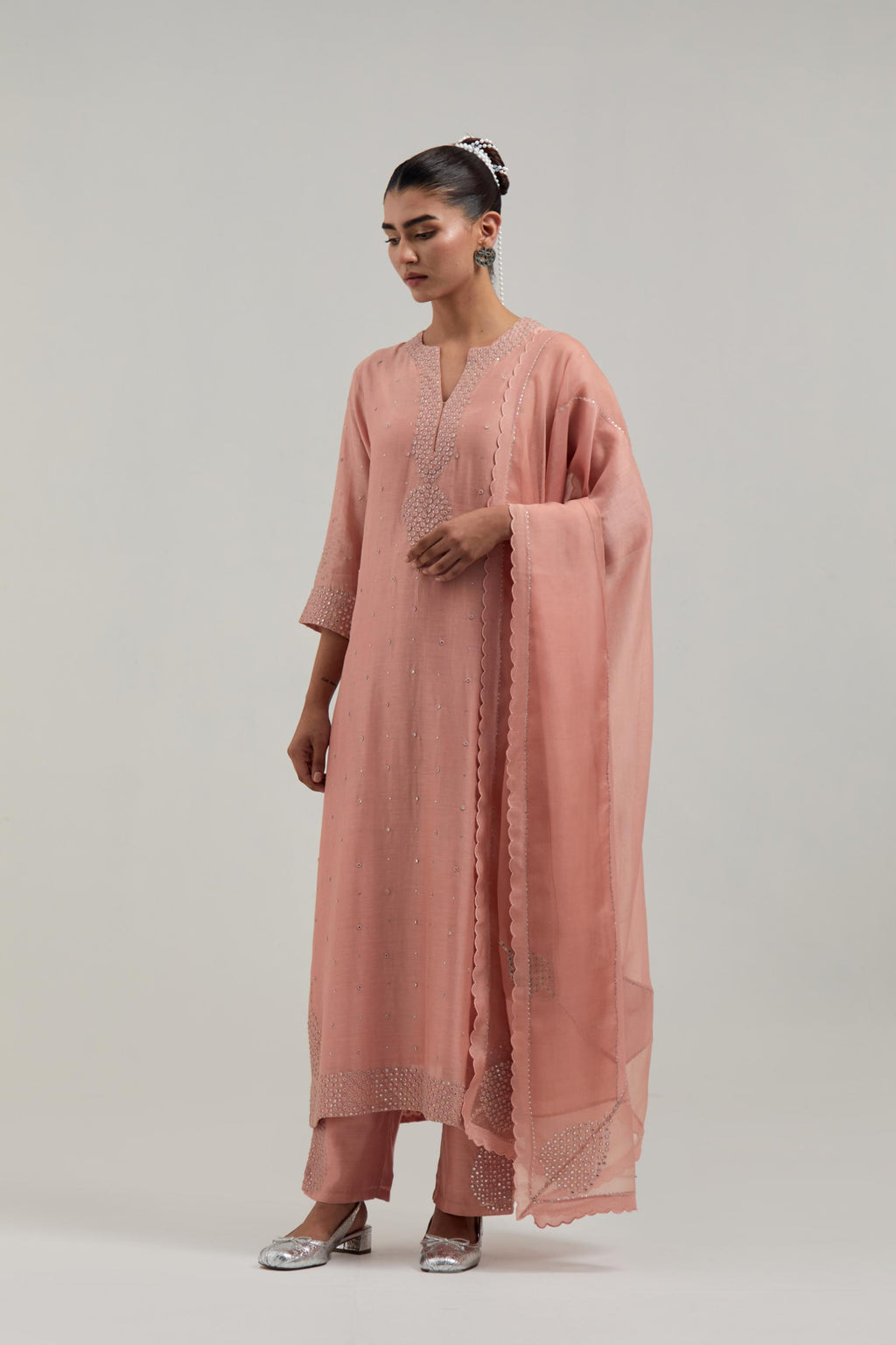 Peach silk Chanderi dupatta with silk organza at the sides, finished with delicate scalloped edges, highlighted by hand-embroidered mirror & sequins work.