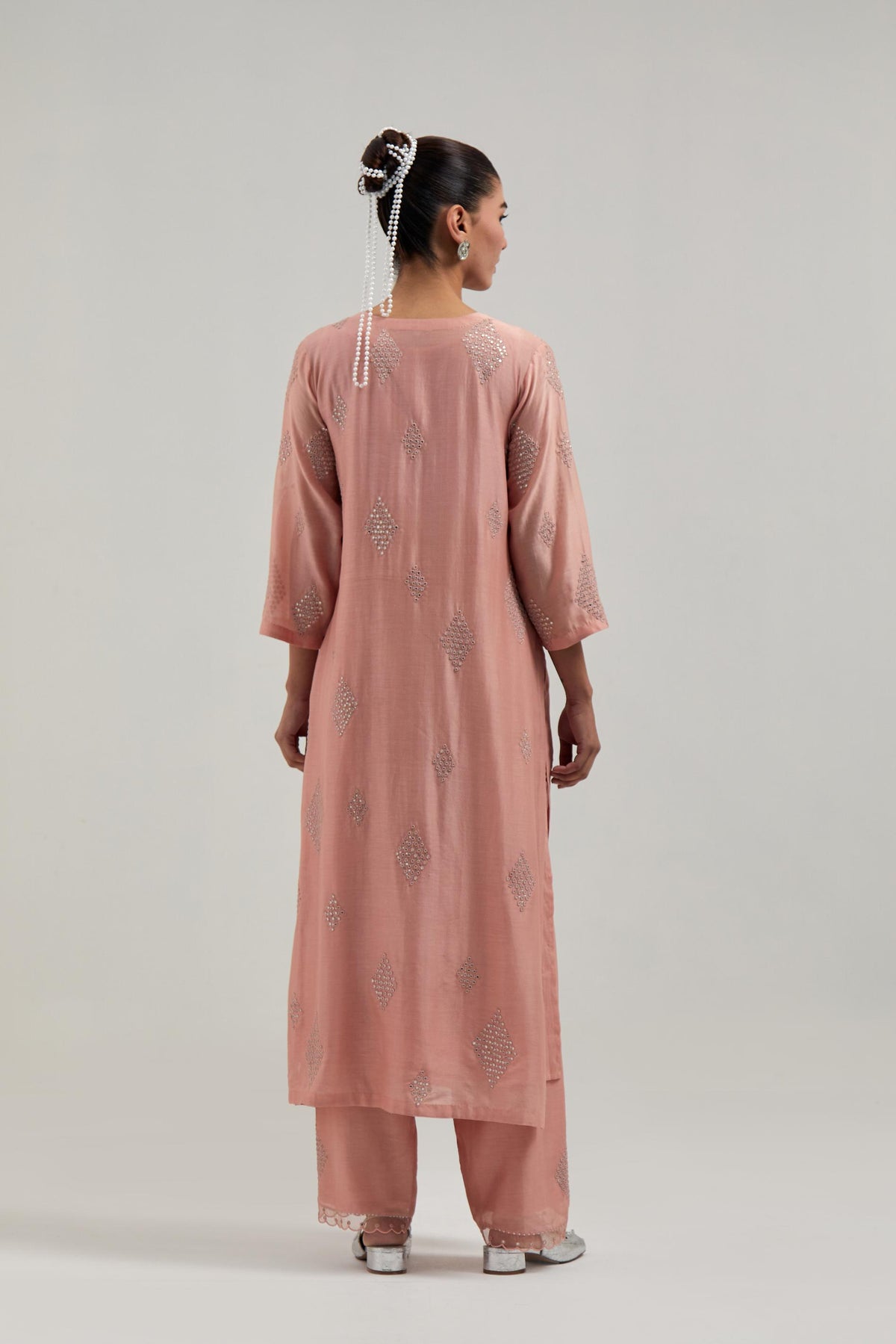 Peach Silk Chanderi straight kurta set with hand embroidered diamond motifs with delicate mirror and sequins work all-over the kurta.