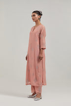 Peach Silk Chanderi straight kurta set with hand embroidered diamond motifs with delicate mirror and sequins work all-over the kurta.