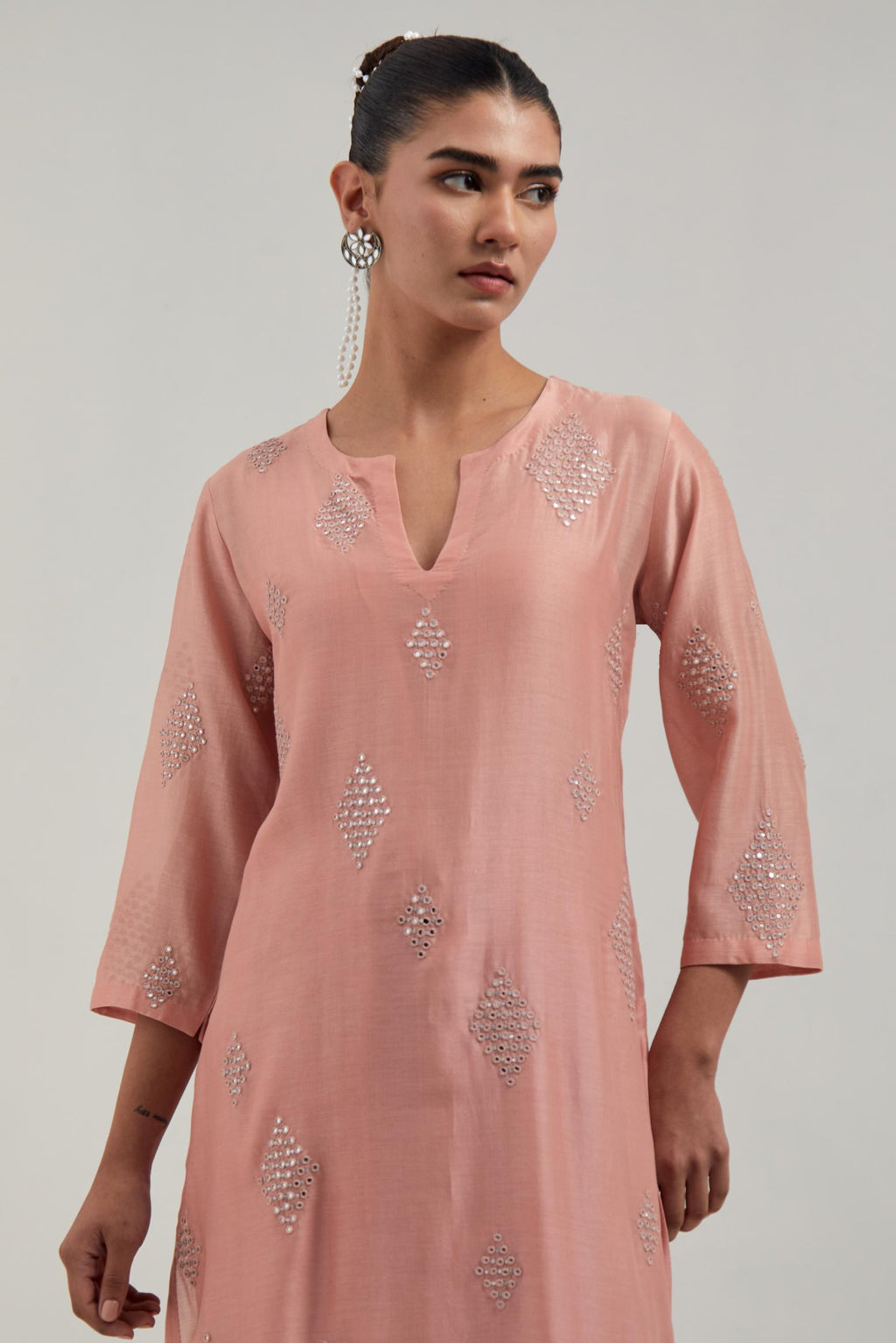 Peach Silk Chanderi straight kurta set with hand embroidered diamond motifs with delicate mirror and sequins work all-over the kurta.