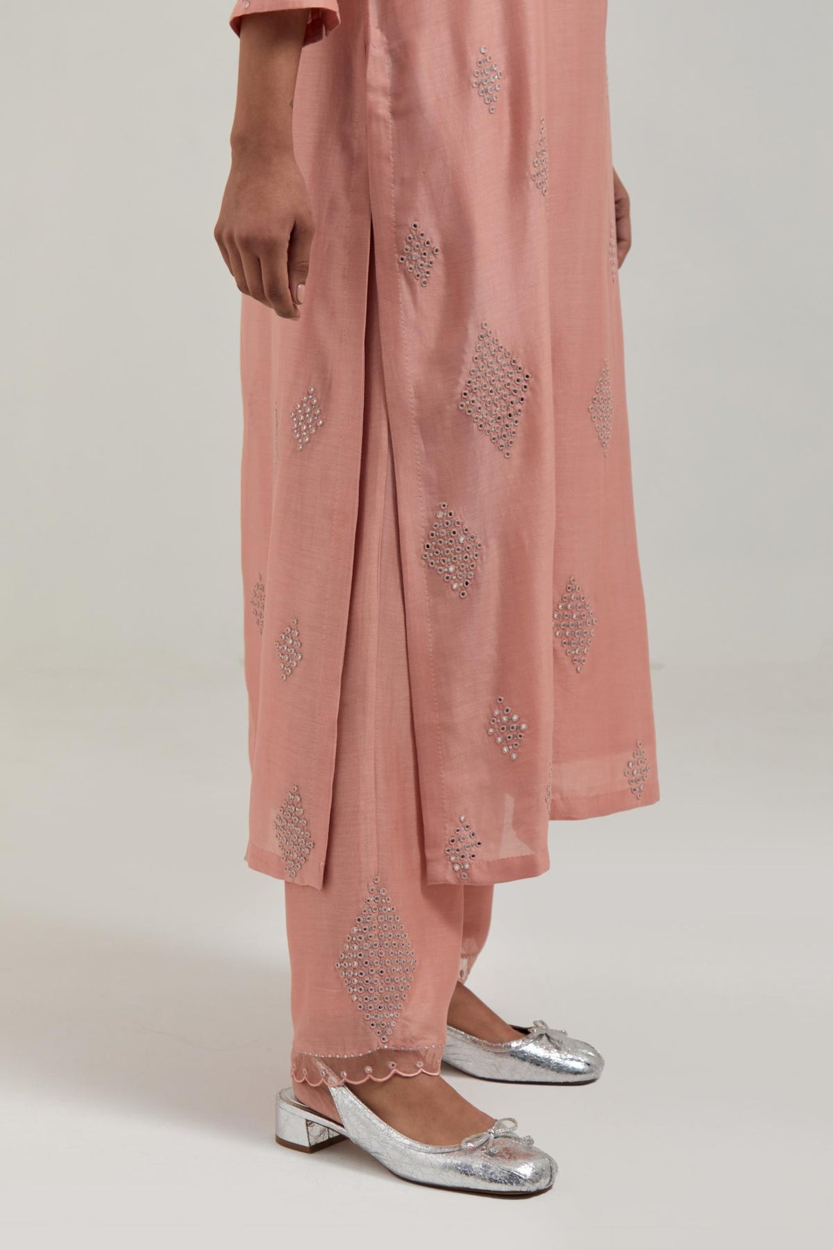 Peach Silk Chanderi straight kurta set with hand embroidered diamond motifs with delicate mirror and sequins work all-over the kurta.