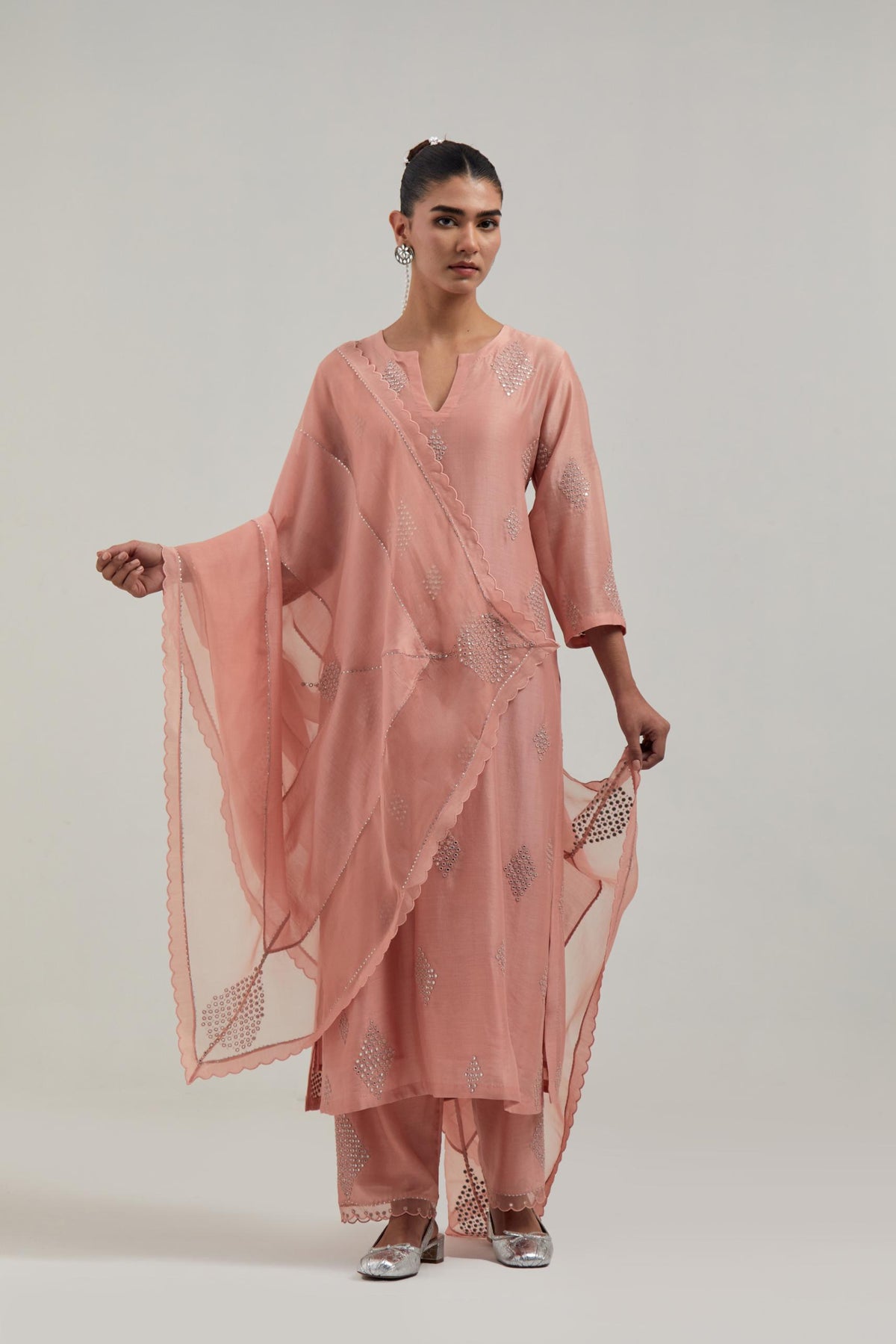 Peach silk Chanderi dupatta with silk organza at the sides, finished with delicate scalloped edges, highlighted by hand-embroidered mirror & sequins work.