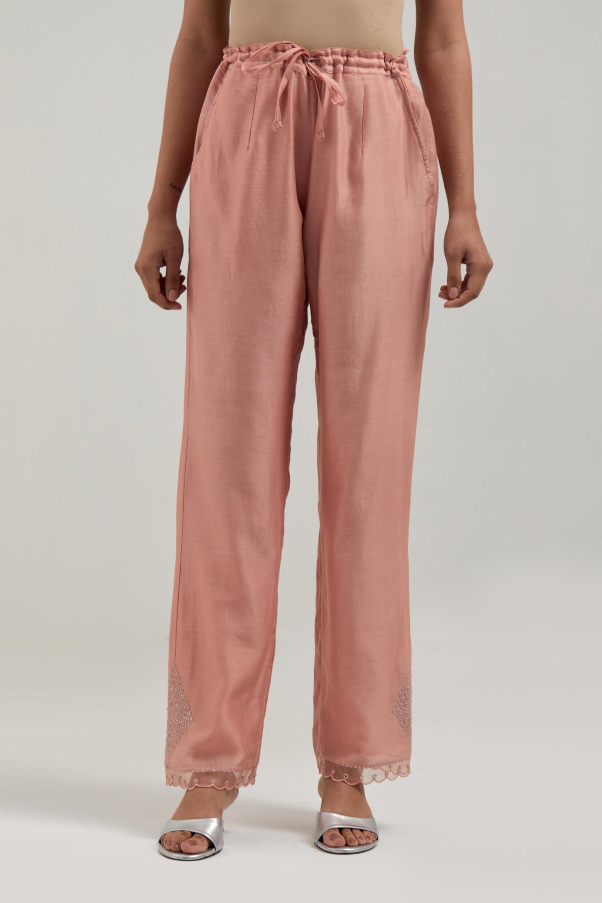 Peach silk Chanderi straight pants with narrow organza scalloped hem and hand-embroidered diamond motifs with delicate mirror & sequins work at the sides.