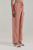 Peach silk Chanderi straight pants with narrow organza scalloped hem and hand-embroidered diamond motifs with delicate mirror & sequins work at the sides.