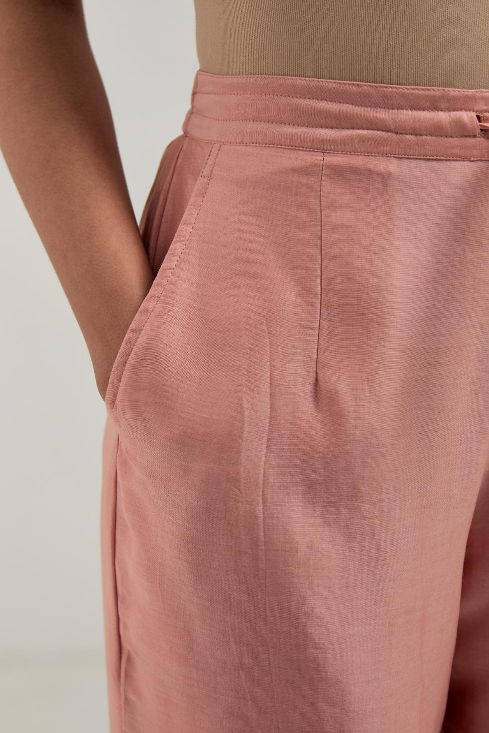Peach silk Chanderi pants with hand-embroidered paisley motifs with delicate mirror and sequins work at the hem.