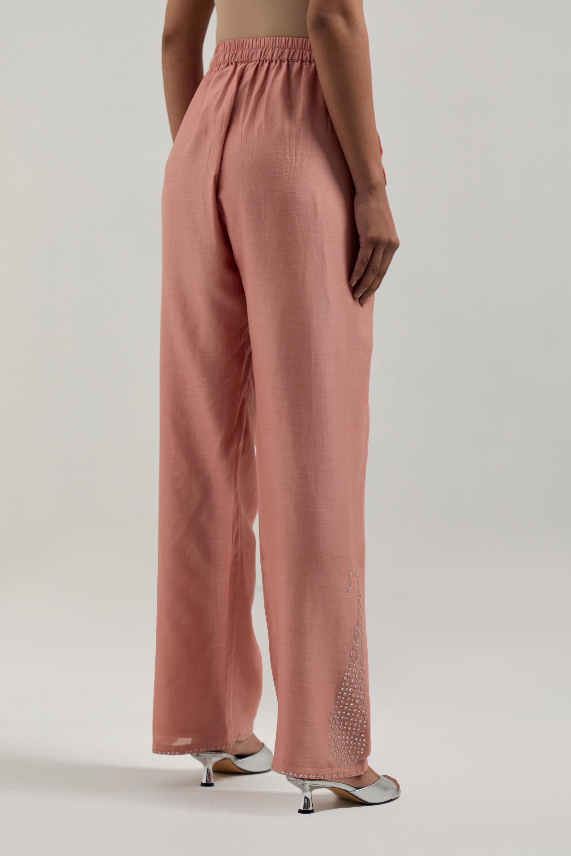 Peach silk Chanderi pants with hand-embroidered paisley motifs with delicate mirror and sequins work at the hem.