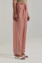 Peach Silk Chanderi pants with hand embroidered leaf motifs with delicate mirror & sequins work at hem.
