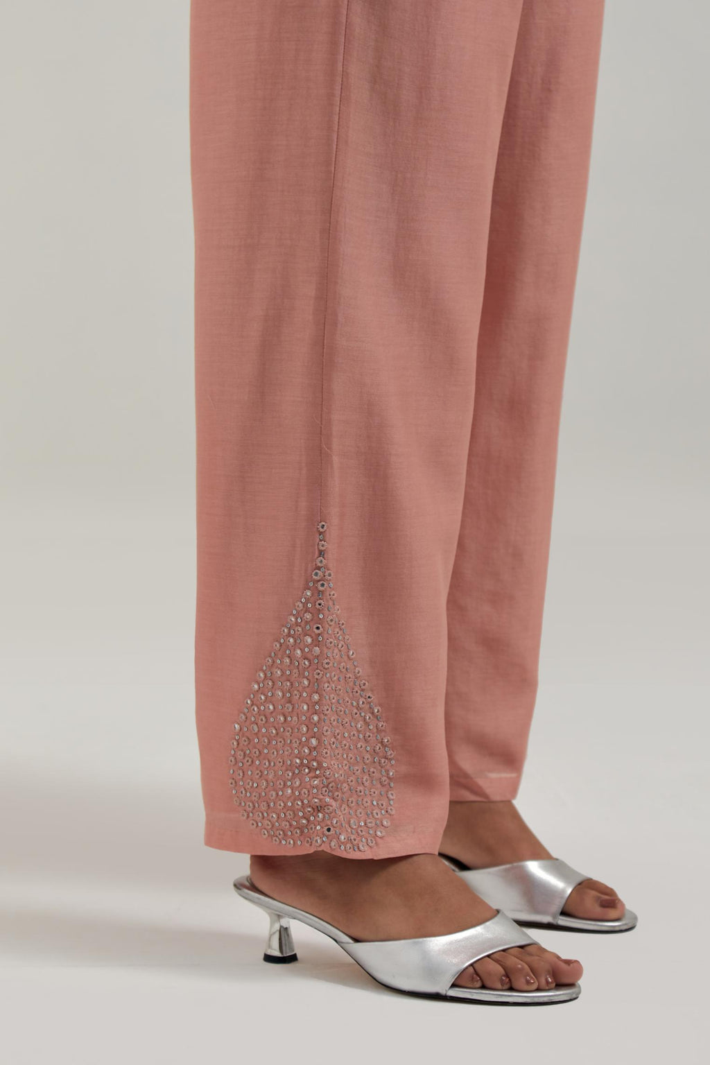Peach Silk Chanderi pants with hand embroidered leaf motifs with delicate mirror & sequins work at hem.