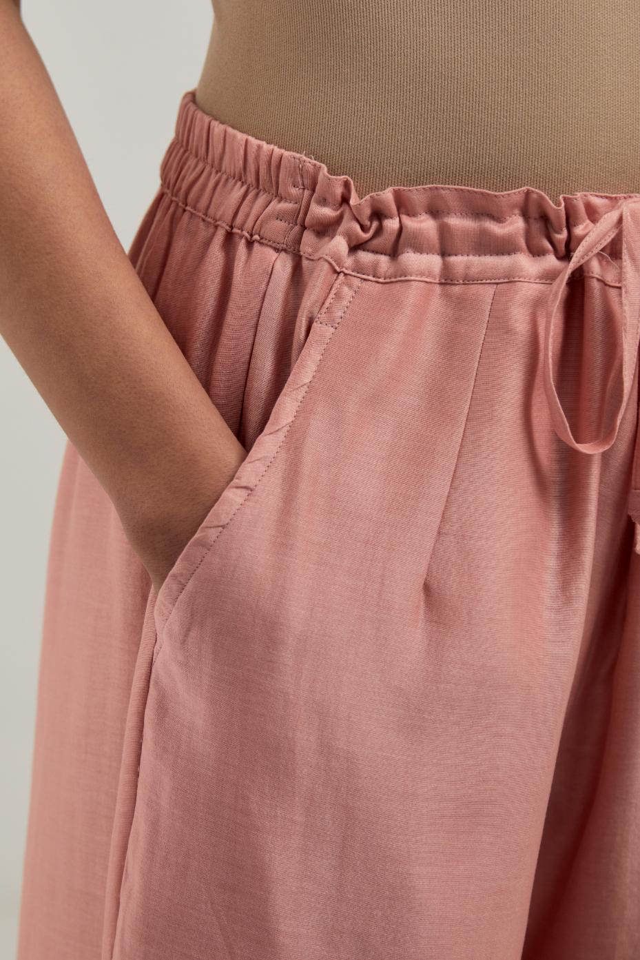 Peach Silk Chanderi pants with hand embroidered leaf motifs with delicate mirror & sequins work at hem.
