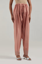 Peach silk Chanderi salwar with hand-embroidered mirror & sequins work in a broad border at the hem.